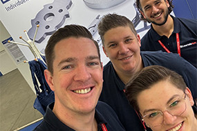 Selfie von vier Laserteile4you Mitarbeiter vor dem Laserteile4you Messestand